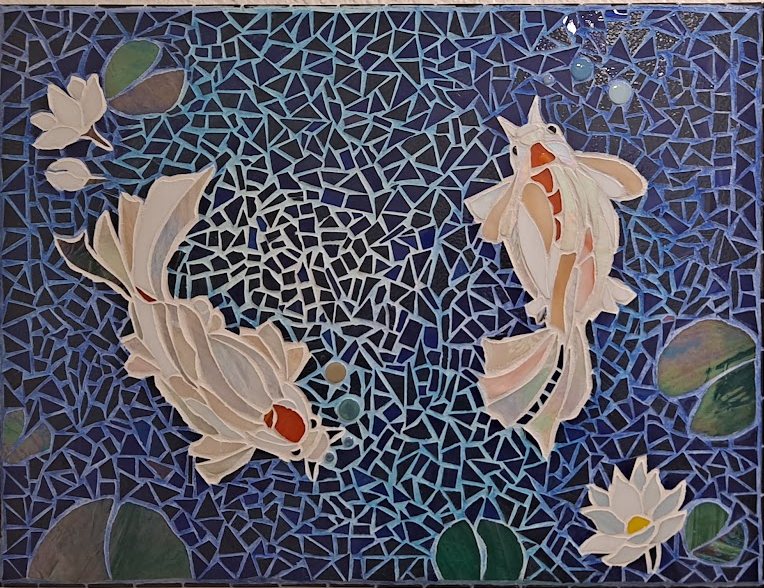 Glass mosaic of two koi and water lilies on a deep blue ground, by Ayesa Kaur