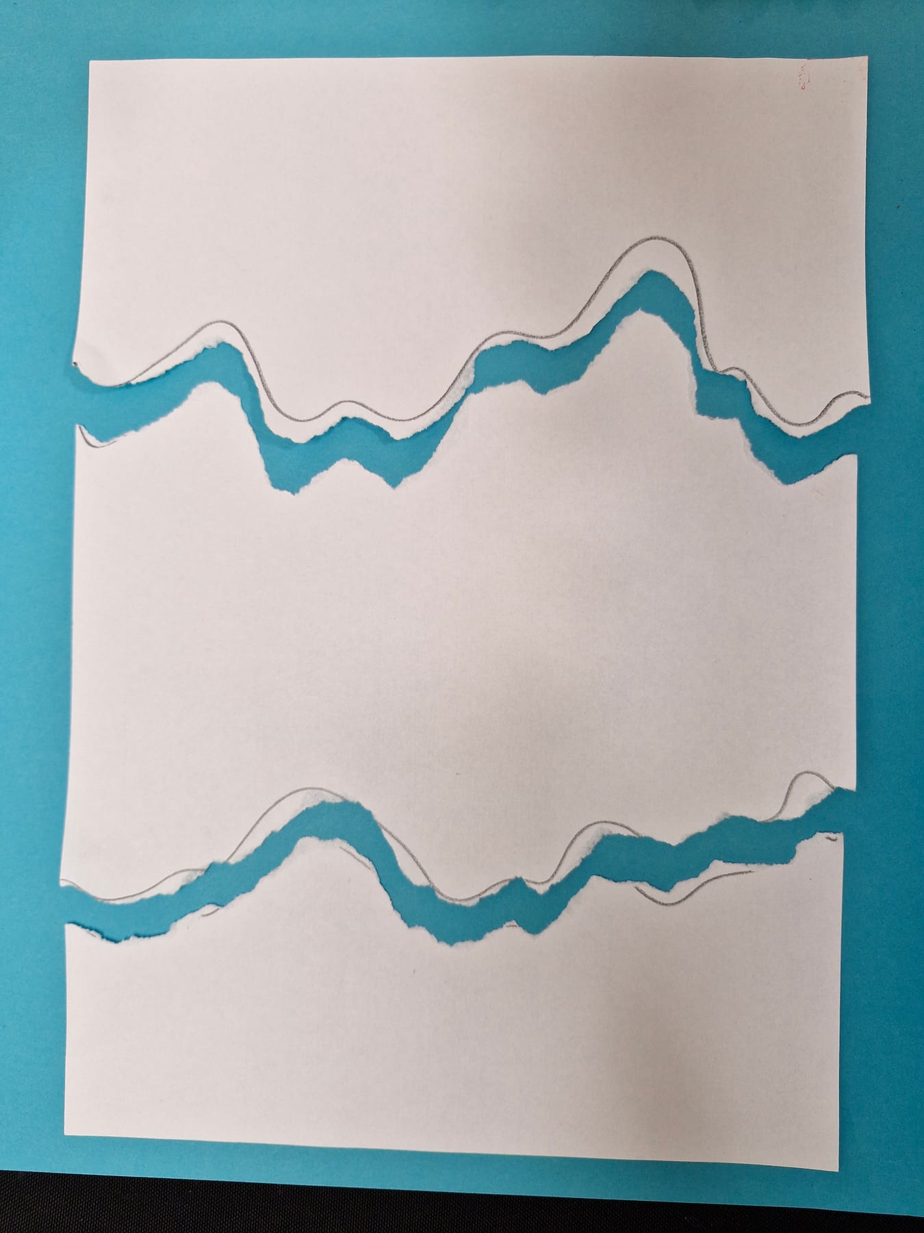 The same white sheet torn along both lines into three pieces, every torn edge soft and fuzzy.